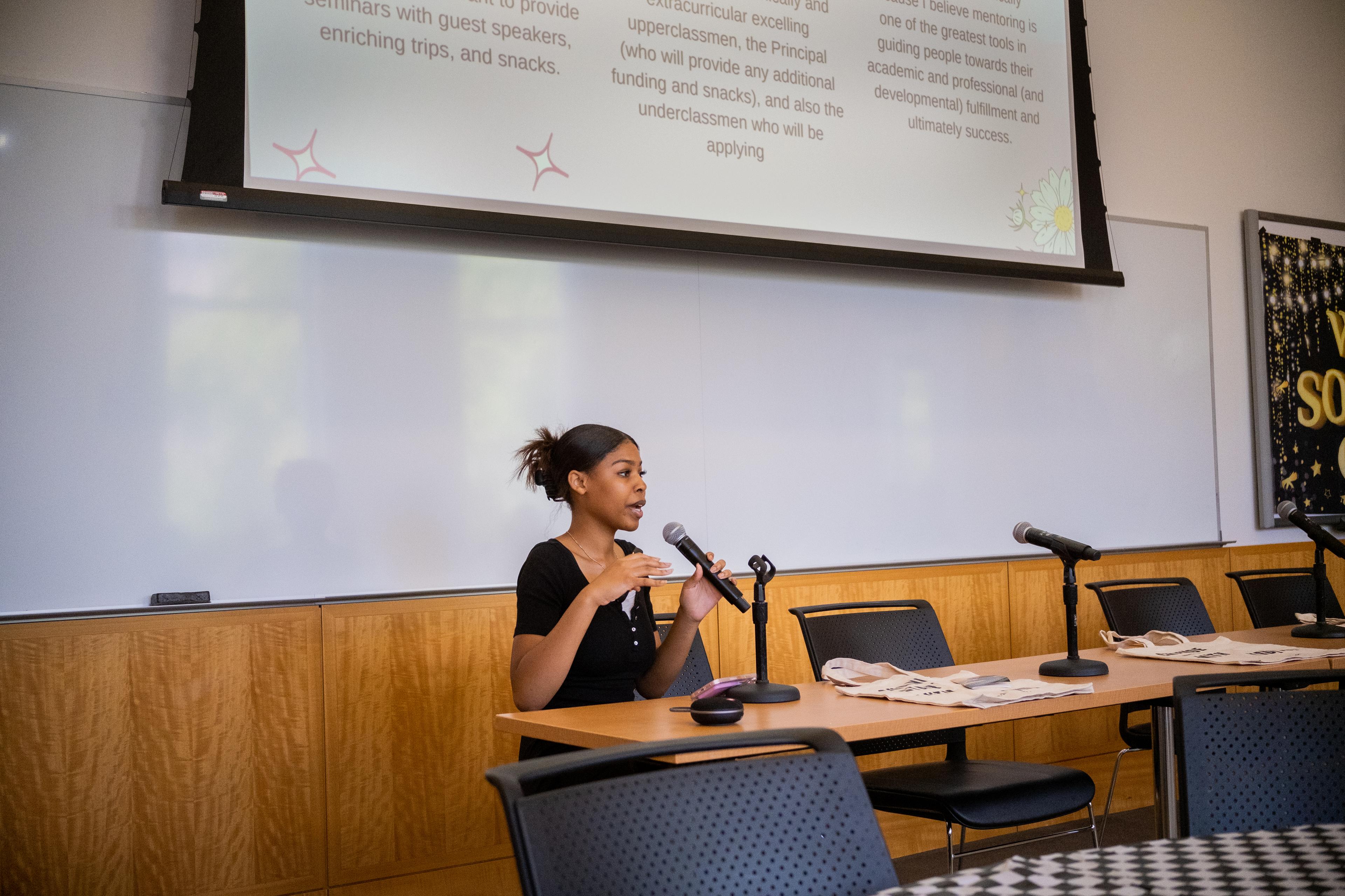 Young Woman speaking on a panel